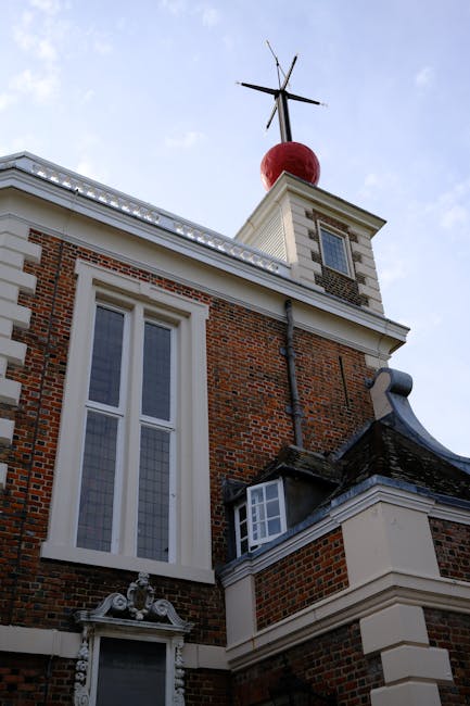A brick archway with the inscription 'Knights Court' spans over a narrow road in a residential area, flanked by two symmetrical three-story buildings with white-framed windows and chimney stacks on th